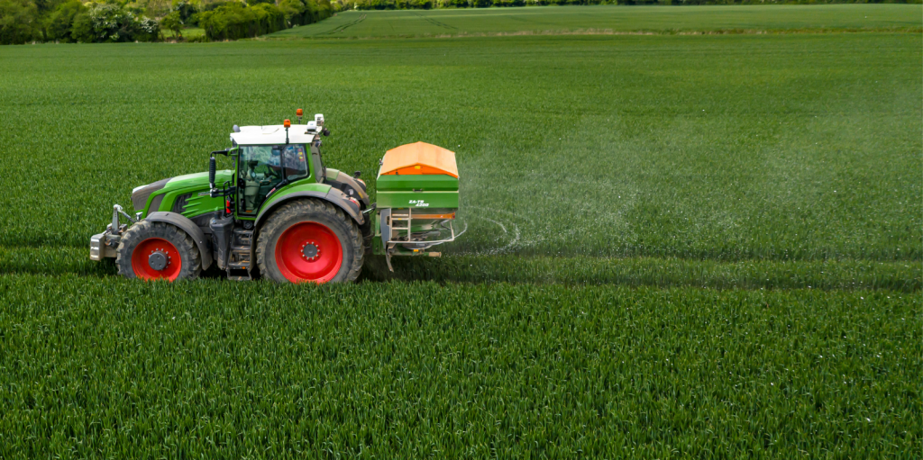 Farmer spreading fertiliser on tillage ground
